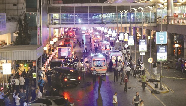 Ambulances and police setting up a perimeter, next to people lying on the ground, after two explosions hit Istanbulu2019s Ataturk airport yesterday.