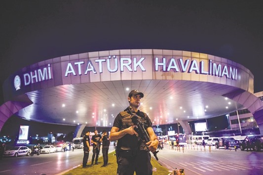 A Turkish riot police officer patrols Ataturk airportu2019s main entrance in Istanbul on Tuesday night. Turkeyu2019s already limping tourism industry is suffering a fresh grievous blow after the latest in a series of attacks targeted at tourists claimed dozens of lives, analysts said yesterday.