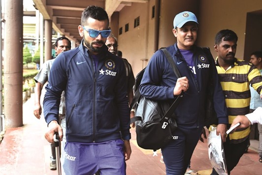Indian cricket team captain Virat Kohli (left) and head coach Anil Kumble leave the National Cricket Academy in Bengaluru. (AFP)