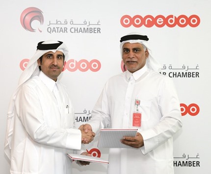 Al-Sharqi and al-Kubaisi sign the agreement under which Qatar Chamber and Ooredoo will work together to u201cbetter representu201d Qataru2019s business community and support the Qatar National Vision 2030.