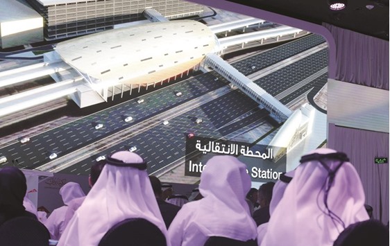 People watch a presentation of the Route 2020 metro expansion project during a press conference yesterday in Dubai.
