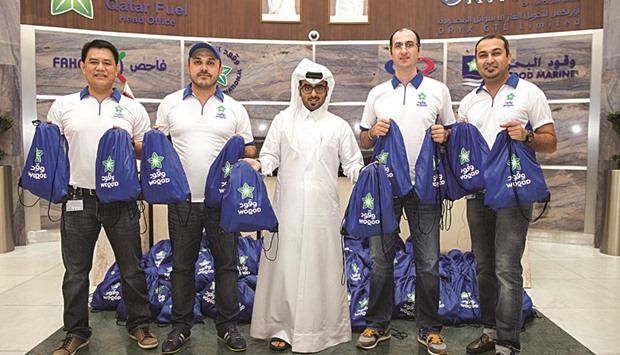 Woqod team with the gift bags.