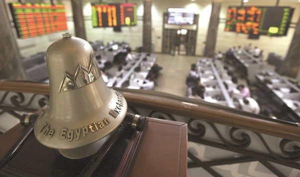 Traders are seen working below the Egyptian Exchange bell at the bourse in Cairo (file). Fund managers are more bearish towards Egypt, fearing an unexpectedly large interest rate hike there in mid-June could be followed by more tightening to fight inflation.
