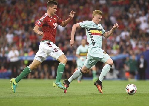 Belgiumu2019s Kevin De Bruyne (right) runs past Hungaryu2019s Richard Guzmics during the Euro 2016 Round of 16 match in Toulouse on Sunday. (AFP)