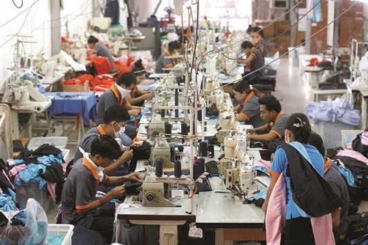 Labourers work at a garment factory in Bangkok. Thailandu2019s factory output rose 2.6% from a year earlier, the industry ministry said yesterday.
