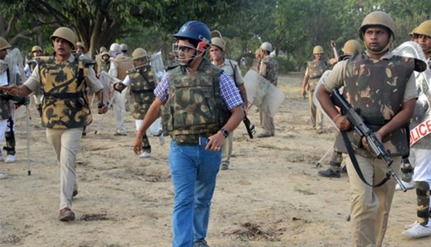 Indian police patrol during clashes with members of a sect said to have been living illegally at the Jawahar Bagh park in Mathura.