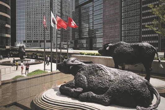 Bull statues displayed outside the Hong Kong Stock Exchange. Chinau2019s investors are piling into Hong Kong equities at the fastest rate in more than a year as they seek shelter against a weakening currency and a worsening economic outlook.