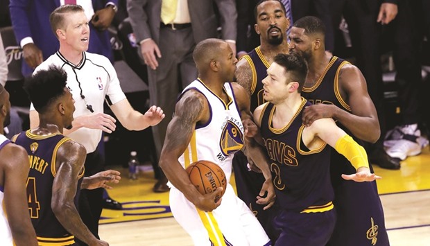 Andre Iguodala (centre) of the Golden State Warriors and Matthew Dellavedova of the Cleveland Cavaliers exchange words during the second half in Game 1 of the 2016 NBA Finals at Oracle Arena in Oakland, California.  (AFP)