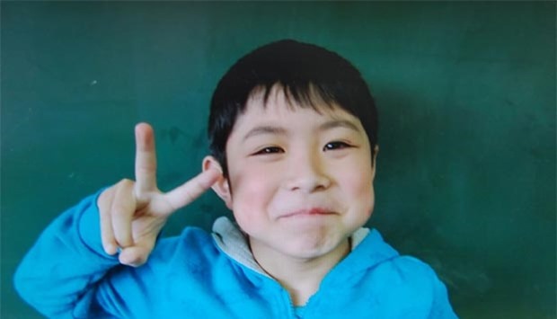 A handout picture provided by an elementary school of Hokuto city shows Yamato Tanooka. The seven-year-old boy missing since being abandoned in a forest in northern Japan nearly a week ago was found alive on Friday.