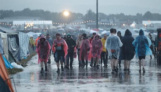 Visitors to the music festival Rock am Ring are seen during a heavy downpour in the west German city of Mendig on Friday.
