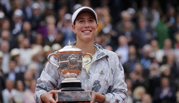 Garbine Muguruza poses with the trophy after beating Serena Williams. Reuters