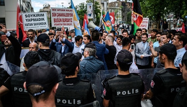 Turkish anti-riot police officers block the street on June 4, 2016 as protesters shout slogans against Germany and hold placards reading ,We do not do genocide, in front of the German consulate in Istanbul after the German parliament recognised as genocide the massacres of Armenians under the Ottoman Empire.