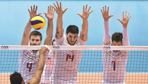 Antonin Rouzier (from left), Nicolas Le Goff and Kevin Tillie of France block the ball from Jhonlenn Barreto of Venezuela during the menu2019s volleyball world final qualification for the Rio Olympics in Tokyo. (AFP)