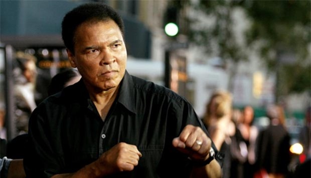 Muhammad Ali jabs at photographers in Los Angeles in this August 2, 2004 file photo.