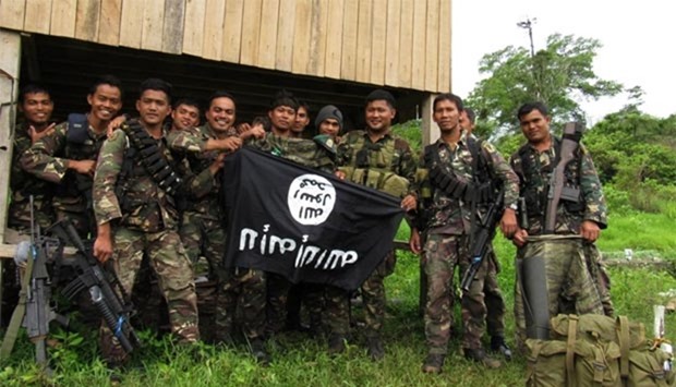 Philippine soldiers displaying the flag used by the Islamic State group after overrunning a militant camp at a remote village in Butig town, Lanao del Sur province, in the southern Philippine island of Mindanao.