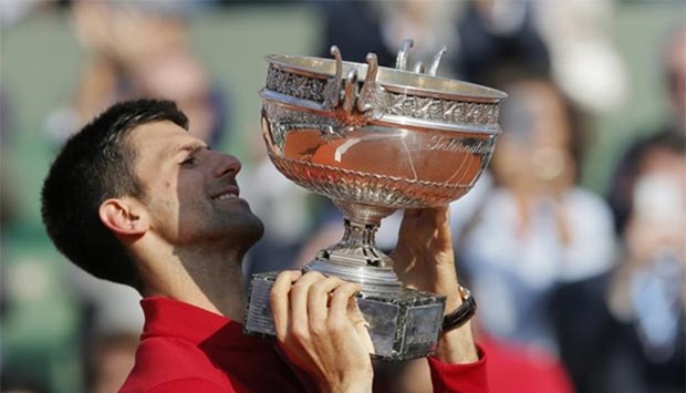 Novak Djokovic holds the trophy after winning the French Open on Sunday