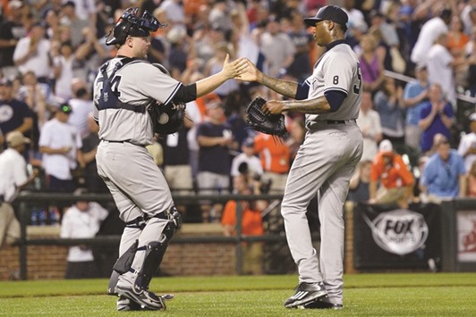 New York Yankees catcher Brian McCann (L) celebrates with relief pitcher Aroldis Chapman after defeating the Baltimore Orioles at Oriole Park at Camden Yards. PICTURE: USA TODAY Sports