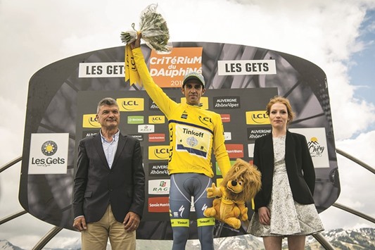 Spanish rider Alberto Contador celebrates on the podium after winning the first stage of the 68th edition of the Dauphine Criterium cycling race in Les Gets, French Alps, yesterday. (AFP)