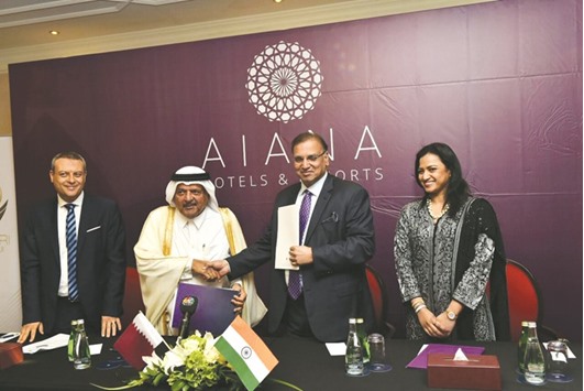 HE Sheikh Faisal bin Qassim al-Thani exchanges the agreement with Vivek Nair as Amruda Nair and Mohamed Shafiek look on.