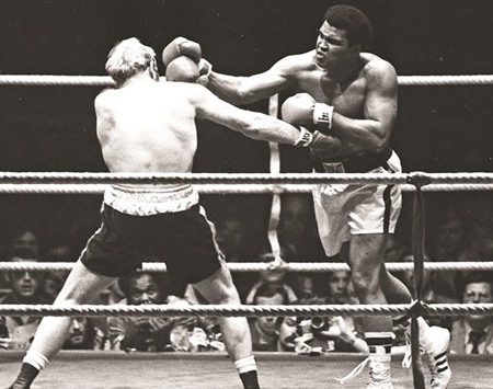 Muhammad Ali (L) punches Richard Dunn while fighting for the WBC & WBA Heavyweight Title in Munich, May 24, 1976.