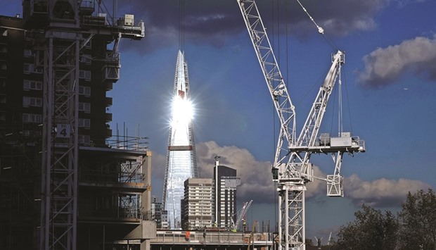The sun reflects off the windows of the Shard skyscraper as cranes stand above building works at a construction site in the Elephant and Castle district of London (file). Qatar is one of the most high-profile investors in London, owning landmarks such as the Shard skyscraper, Harrods department store and Olympic Village, as well as luxury hotels.