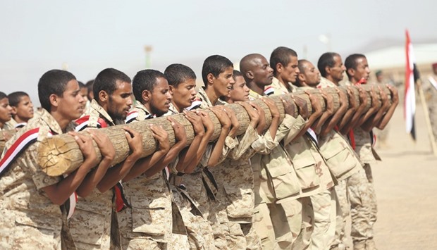 Soldiers loyal to Yemenu2019s President Abd-Rabbu Mansour Hadi take part in a parade in the countryu2019s northern city of Marib yesterday.