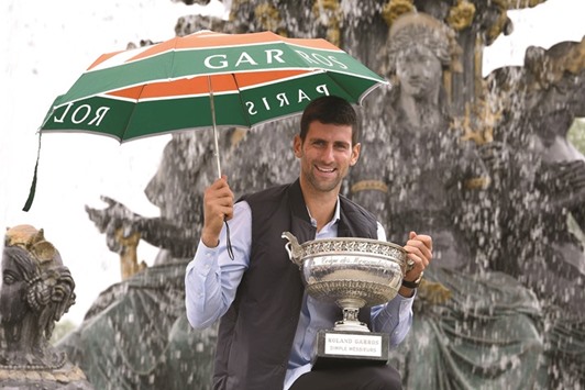 Novak Djokovic poses with his French Open trophy on Place de la Concorde in Paris yesterday. (AFP)