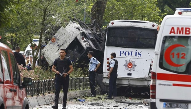 Police walk near a Turkish police bus which was targeted in a bomb attack in a central Istanbul district, Turkey, June 7, 2016. REUTERS