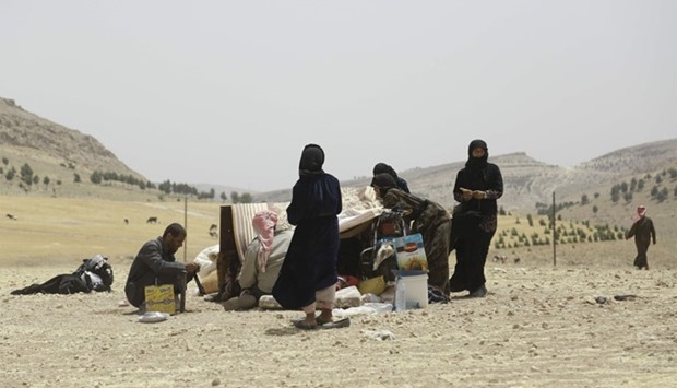 Syrian families, who fled the assault launched by Arab and Kurdish forces against Islamic State (IS) group fighters in the town of Manbij, arrive at an encampment on the outskirts of the town, 20km away from the center.