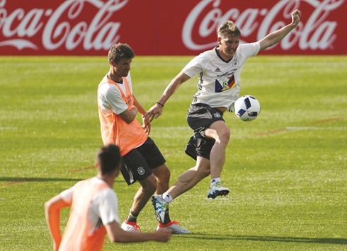 Germanyu2019s Bastian Schweinsteiger and Thomas Mueller take part in a training session at Stade Camille Fournier in Evian-les-Bains, France, yesterday. (Reuters)
