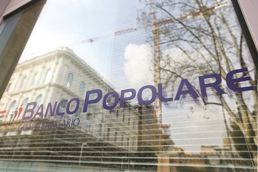 The Banco Popolare logo is seen on a window at one of the bank branches in Rome. Italyu2019s fourth-biggest bank is raising cash to boost provisions against loan losses ahead of a government-backed merger deal with rival Banca Popolare di Milano, to forge the countryu2019s third-biggest lender which will have assets totalling u20ac171bn.