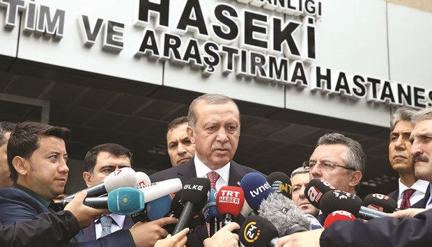 Turkish President Tayyip Erdogan talks to media outside the Haseki hospital in Istanbul yesterday.