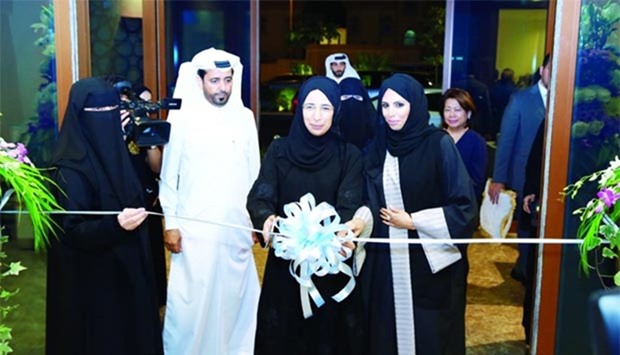 HE the Minister of Public Health Dr Hanan Mohamed al-Kuwari opens Al Thumama Health Centre as Dr Mariam Abdul Malik and other officials look on.