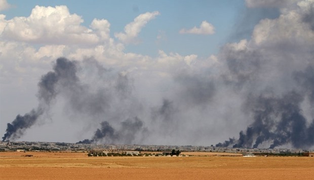 Smoke rises from Manbij city, Aleppo province, Syria