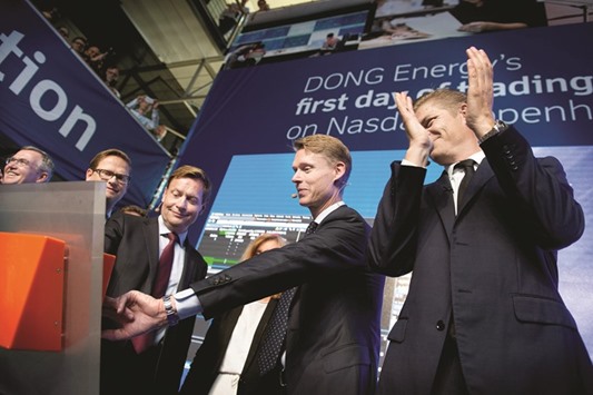 Dong Energy CEO Henrik Poulsen presses the button during the companyu2019s stock market debut at the companyu2019s headquarters in Copenhagen yesterday.