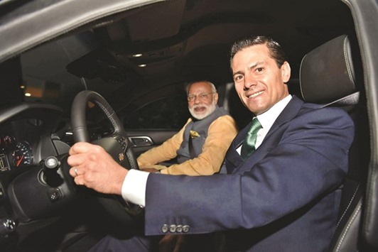 Mexican President Enrique Pena Nieto drives Prime Minister Narendra Modi to a restaurant in Mexico City on Wednesday.