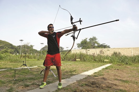 Venezuelan Olympic team archer Elias Malave aims his arrow during a training session in Maracay, in the state of Aragua, Venezuela. (Reuters)