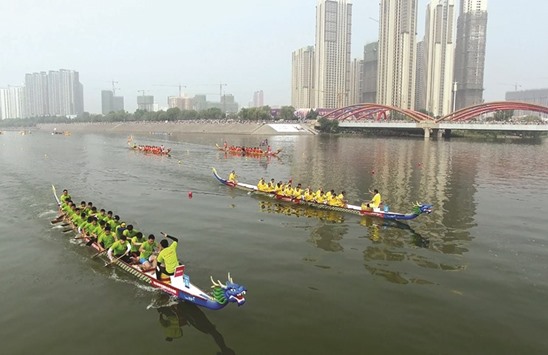 Teams compete during the Dragon Boat Festival in Luoyang, in Chinau2019s Henan province.