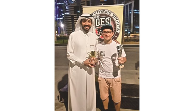 QES founder Farhan al-Sayed (left) awards Alon, winner of the Best Run and Slide Jam in the longboard event.