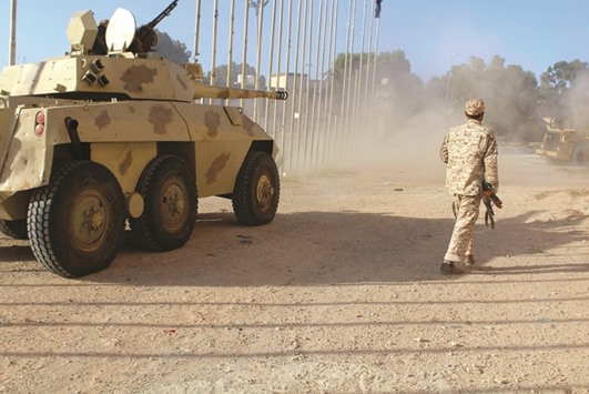 An armoured vehicle belonging to forces aligned with Libyau2019s unity government drives on a road to Sirte yesterday.