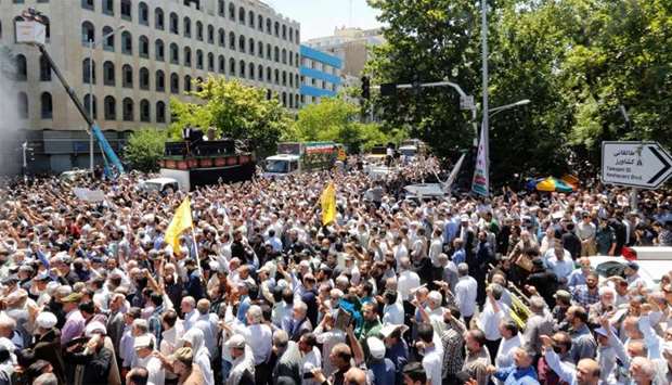 Iranians march during the funeral of the victims of the attacks on Tehran's parliament complex and shrine 