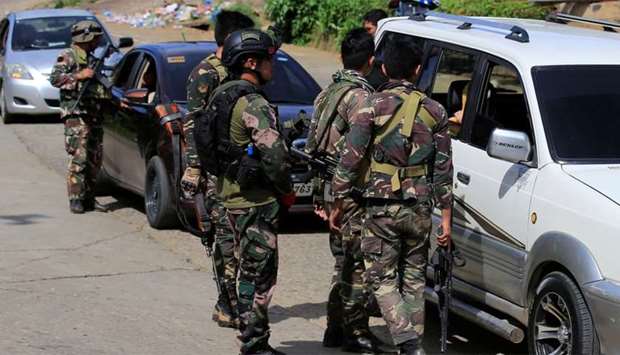 Philippine National Police Special Action Force personnel man a checkpoint in Marawi city