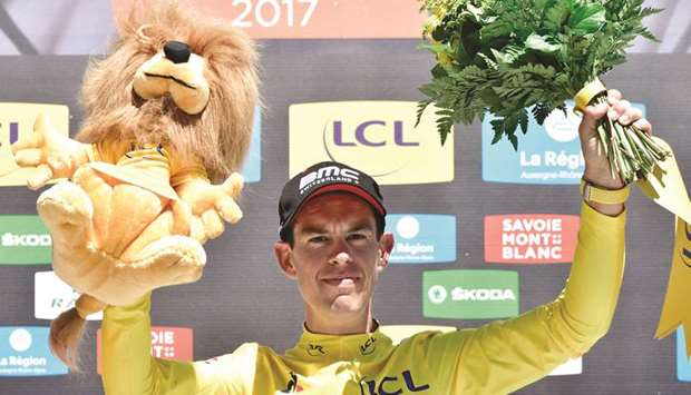 Australiau2019s Richie Porte celebrates his overall leader yellow jersey on the podium at the end of the 168km seventh stage of the 69th edition of the Criterium du Dauphine cycling race between Aoste and Lu2019Alpe du2019Huez. (AFP)