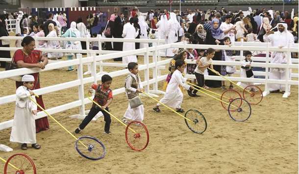 Children take part in a traditional game during Qatar Foundationu2019s Garangao celebrations at Al Shaqab.