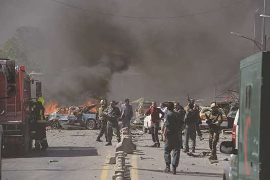Security forces arrive at the site of a car bomb attack in Kabul yesterday.