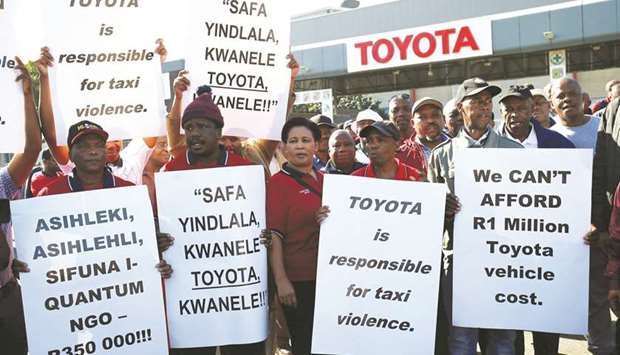 Minibus taxi operators block the entrance to the Toyota manufacturing plant during morning rush hours as part of a protest against Toyota over model pricing in Durban.