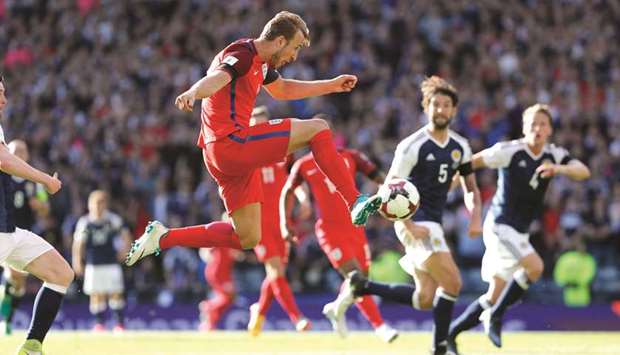 Englandu2019s Harry Kane (left) in action against Scotland during their 2018 World Cup qualifying match yesterday. (Reuters)