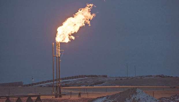 A gas flare burns at an oil well site near Sidney, Montana, US. Explorers added more US oil rigs last week, extending their record streak of expansion despite signs that excessively robust shale production might kill any hope of re-balancing crude markets this year.