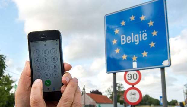 A man uses his mobile phone in Boeschepe at the Franco-Belgian border