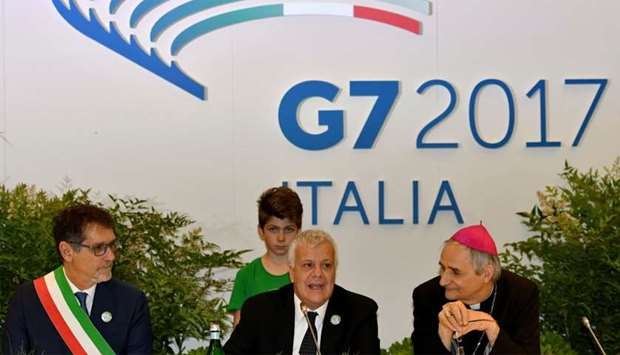Italian Minister of the Environment Gian Luca Galletti (C), mayor the Italian city of Bologna Virginio Merola (L) and cardinal Matteo Maria Zuppi look on on during a meeting at the G7 Environment summit in Bologna